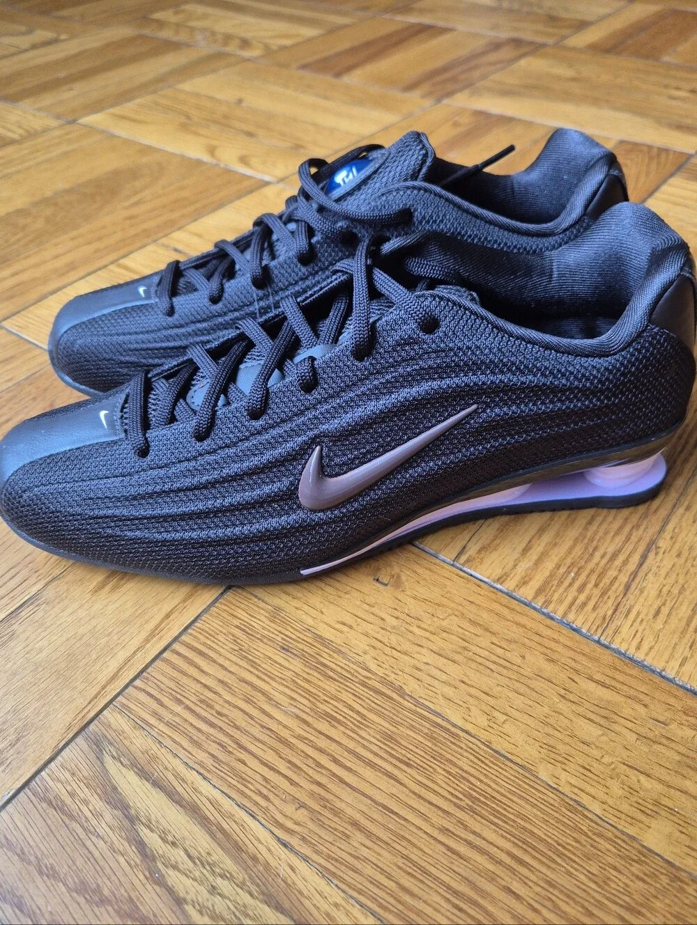 Nike Women’s Black Sneakers with Rose Metallic Swoosh
